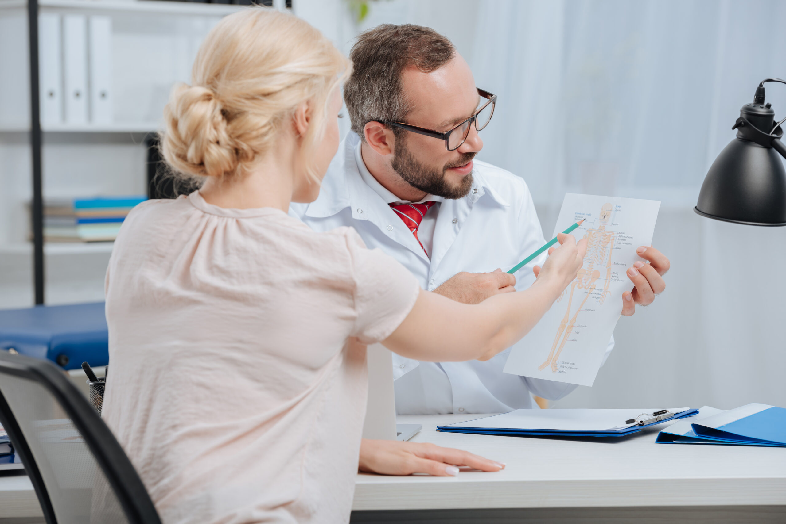 female patient having appointment with chiropractic in clinic